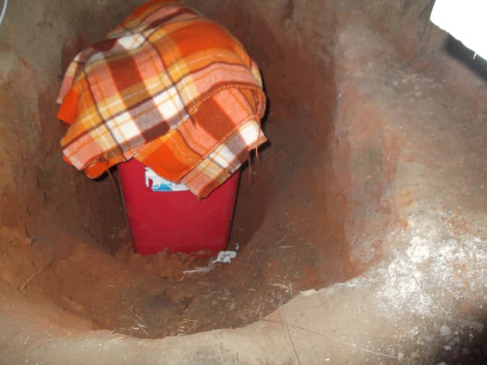 The deepest section holds a plastic bin full of water, below the steps and built-in seating.