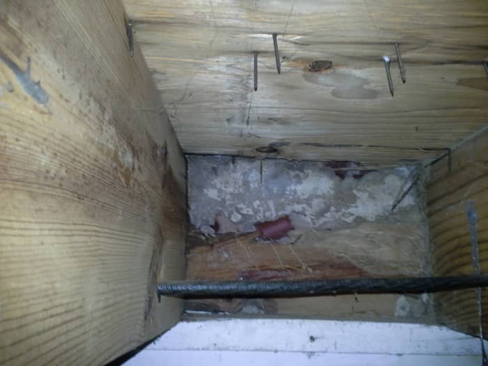 However, thorough probing revealed completely destroyed part of the rim joist. Notice the gray concrete slab of our patio was visible from inside our house!