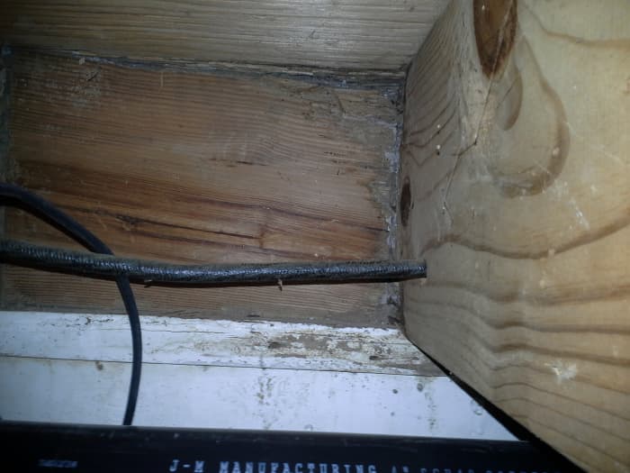 Water penetrating wood is an early indication of trouble. By the time my husband spotted it, termite droppings were already visible. Spot treatment was sufficient for this localized area.