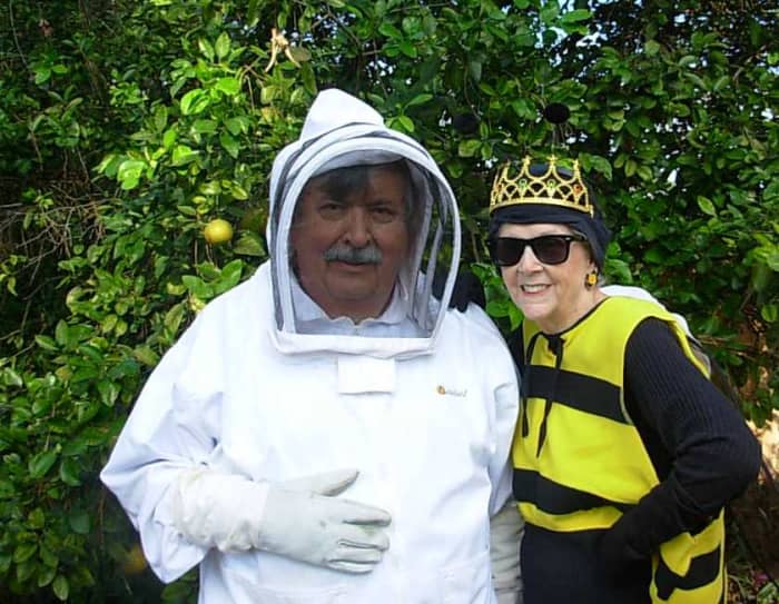 Jim Arnold is dressed in a beekeeping suit and Linda Fessel is dressed as his Queen Bee for Halloween.