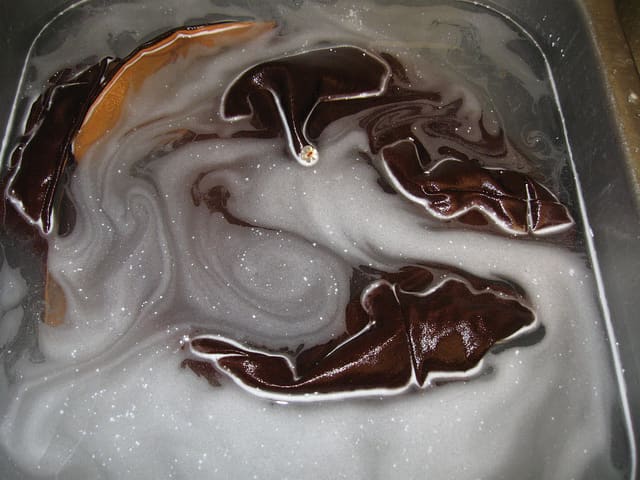 Use powdered oxygen bleach to soak garments affected by laundry color bleed.