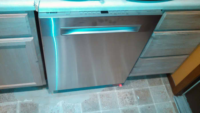 This Bosch is so quiet that it shines a light on the floor so that you know it is running! Notice the red spot on the floor on the right side.