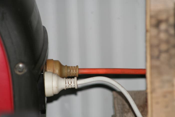 The Honda EU20i/EU2000i has two outlets side by side for extension cords. We have one (orange) permanently connected to top up our solar battery bank, and the other extension cord runs to a power board (i.e. multiple outlets) within the house.