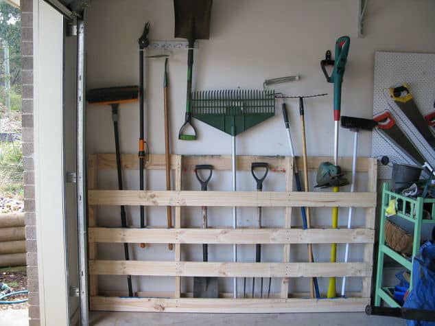 This large pallet keeps shovels, racks, and other large yard equipment organized with a minimal footprint in the garage.