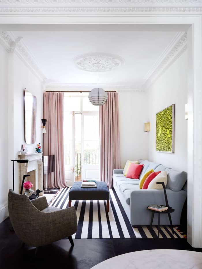 Placing the curtain rod right below the ceiling and hanging curtains that go all the way to the floor makes the ceilings appear higher.
