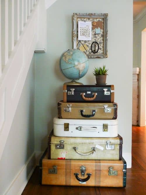 Placing the globe and plant on top of the suitcases pulls the display together. No one will ever know that you use the suitcases as storage.