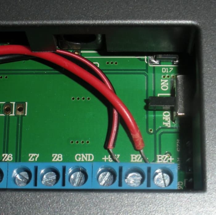 The red wire is positive and connects to BZ+. The black wire is negative and connects to BX-. Other terminals can be used to connect wired sensors.
