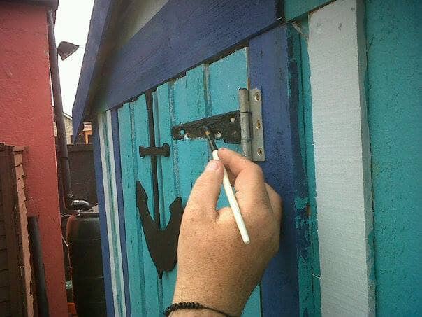 Painting the hinges on the garden shed