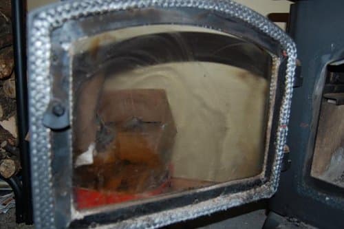 Once your glass starts looking like this, spray some water on the glass and wipe it off with paper towels until the paper towels no longer contain no more black residue.