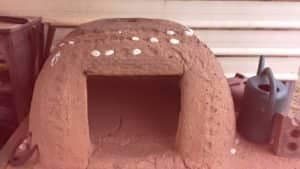 The first cob pizza oven we built for ourselves: showing vent hole at the top, and stones for decoration
