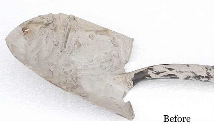 BEFORE: Shovel covered with dried on concrete.