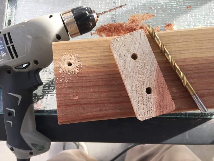 Drill a small guide hole using the depression to guide the drill bit, or use the depression to start driving the screw.