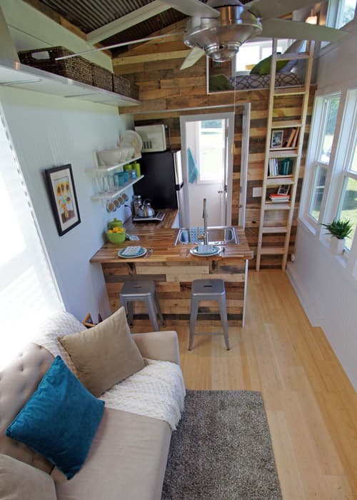 An open concept between the kitchen and living room gives the illusion of more space in this tiny house.
