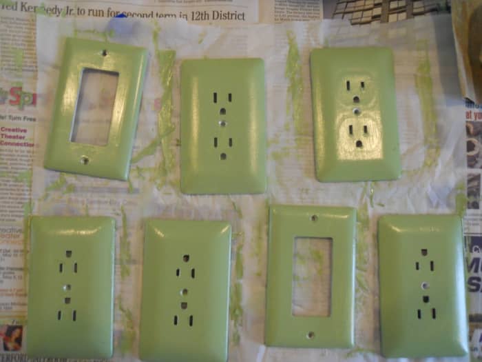 I spread out my outlet and switch covers on parchment paper, so they would not stick. Using a small brush, I painted them. They needed 2 coats.