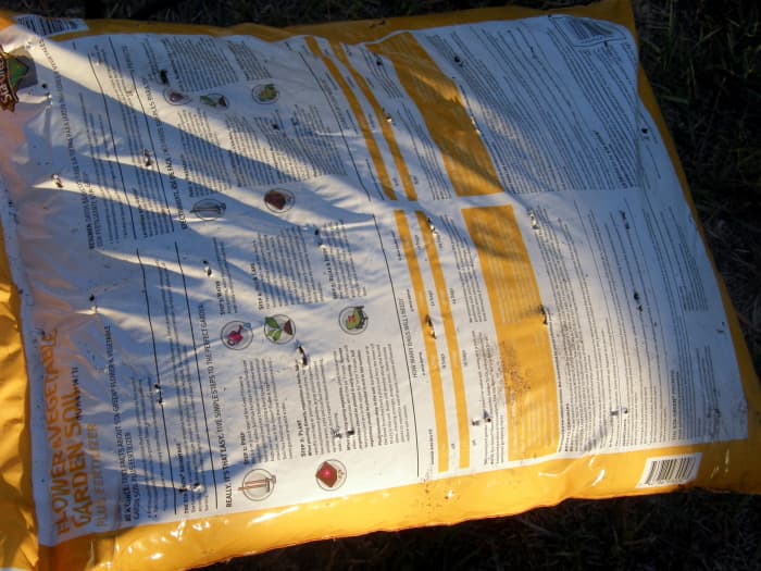 Use a screwdriver to punch some holes. Plant roots will use these holes to grow down into the soil below the bags and to allow for drainage.