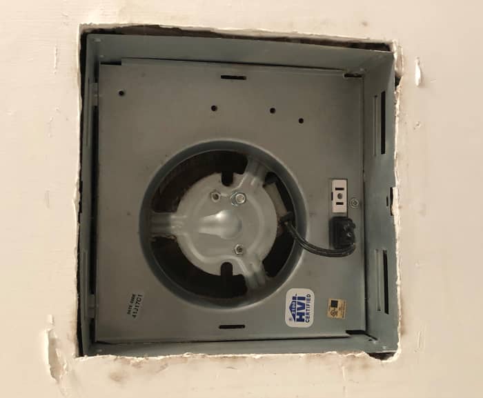 The bottom of the fan housing should rest above the bathroom ceiling's finished surface. This keeps the louver tight against the ceiling.