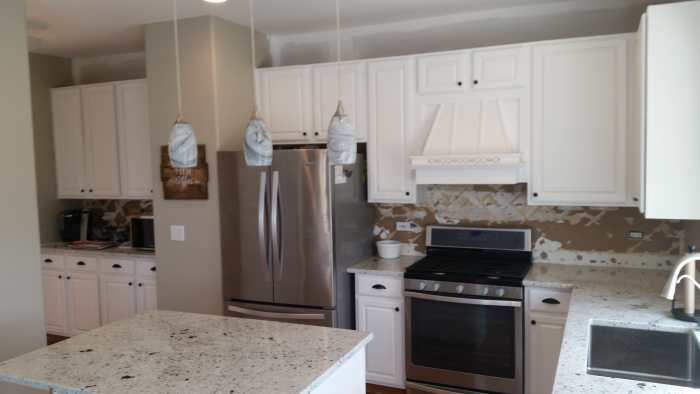 Oak cabinets freshly painted white
