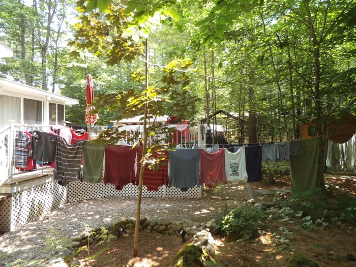 I save 1 or 2 dollars per load by hanging my clothes out. I don't have much of a back yard, so the shirts dry on hangers on the deck railing.