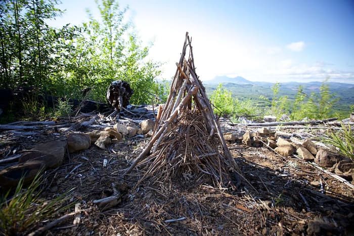 A teepee fire awaiting lighting. The tinder is at the very center, surrounded by successively larger pieces of fuel. You can follow this model on a smaller scale.