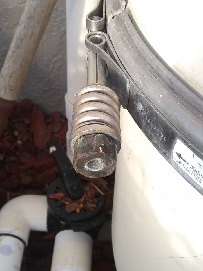 There are two 7/8" band clamp bolts. One on each side. Loosen one of them, and remove the other.