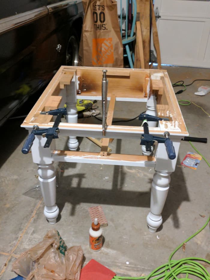 Using clamps and wood glue, I put the table back together and left in the sun to dry before reattaching the table top.