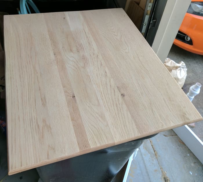 This is the table top after I belt-sanded off the old stain and then used a palm sander with a fine grit sandpaper to smooth it out before staining.