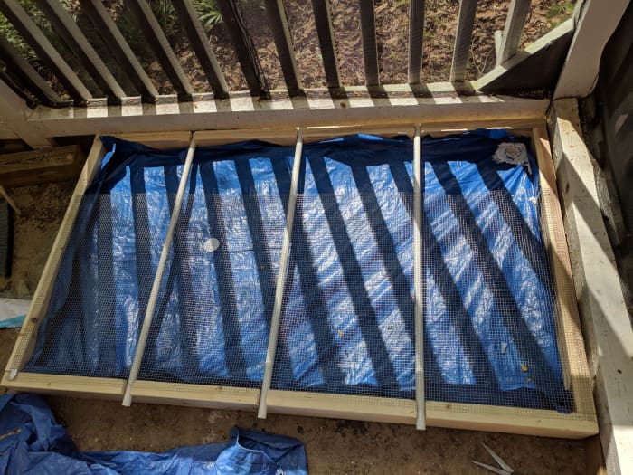 I forgot to take a picture before I started putting the hardware cloth and PVC pipe inserts -- but look past that and you'll see my tarp. I recommend a shower curtain instead. staple the shower curtain in to keep liquids off the plywood,