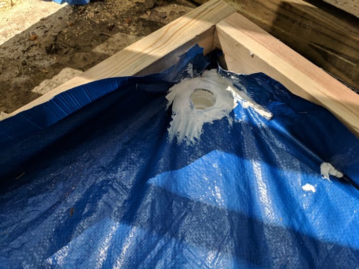 here you'll see how I've sealed in my drainage pipe all the way around the opening and on the tarp.