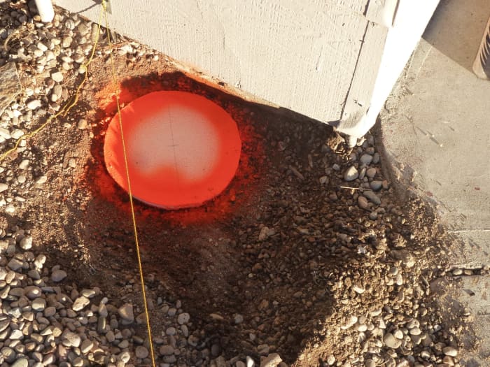 The template used to mark where the post hole will be dug. The string is stretched above it, making measurements possible. Notice that the string is not in the center of the hole; the string is the side, not the center, of the post.