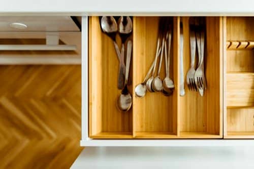Customized utensil inserts are great but costly. Use expandable silverware organizers to save money.