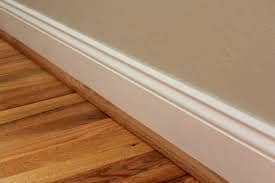 See that strip that covers the gap between the baseboard and the floor? That's what we call quarter round trim. Sometimes it's painted, but sometimes (as in this photo) it's not.