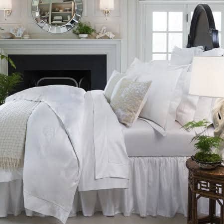 Luxurious bed linens add an elegant touch to the bedroom.