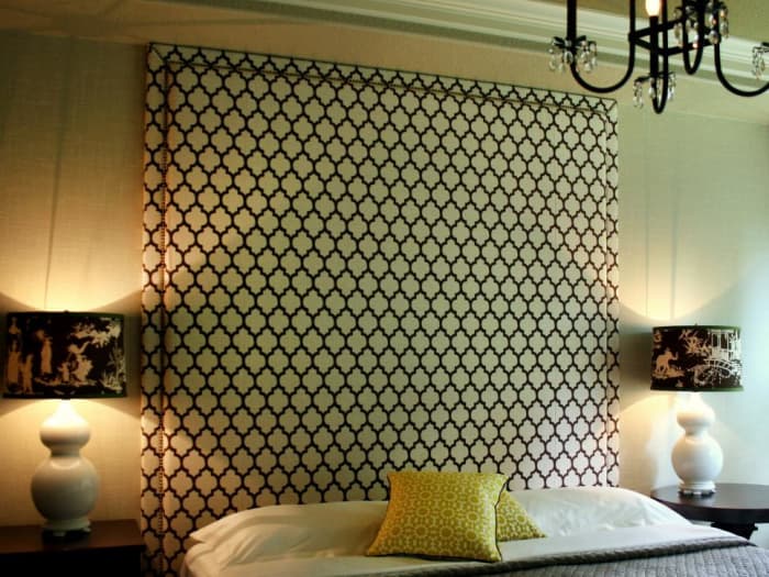A towering headboard in an elegant pattern creates the main focal point in the bedroom.