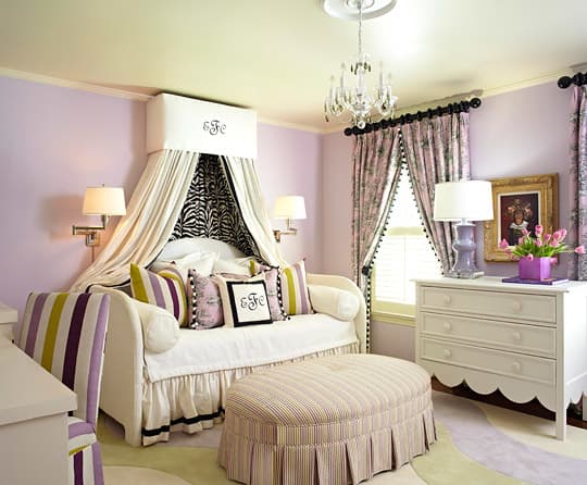Traditional draperies paired with a bed canopy gives the bedroom a warm, and cozy feel.