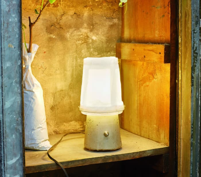 With just a handful of common materials such as yogurt containers and cement, you can make your own DIY yogurt lamp just like this one.