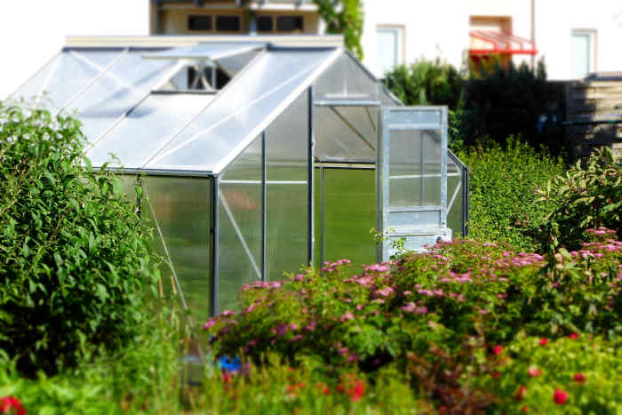 A small polyurethane garden greenhouse suitable for a home gardener or hobbyist. 