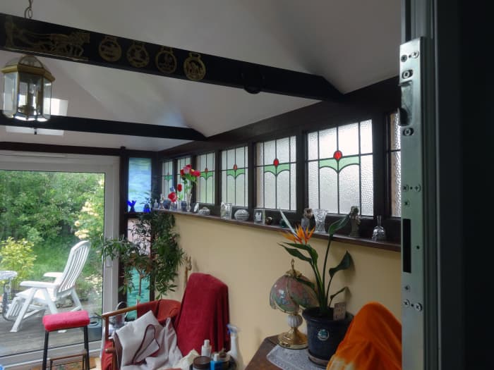 North facing coloured glass windows in the conservatory which refracts evening sunlight into our living room; viewed from our living room, through the open French door.