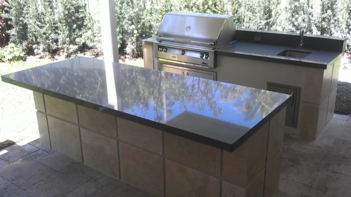 An outdoor kitchen island is handy for food prep, bar set-up, a breakfast counter and plenty storage.