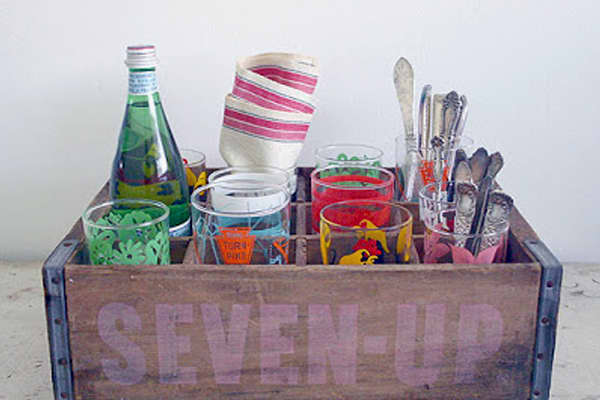 You can find everything you need for outdoor entertaining using an antique soda crate. Fill it with glassware, flatware, barbecue accessories and more.