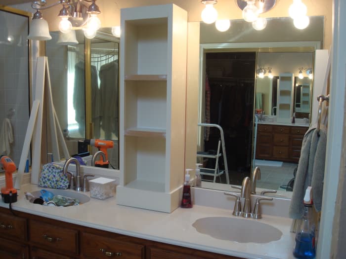 Notice here that the lighting fixtures are still in progress, the mirror edges are still unframed, and the crown molding is not yet installed.