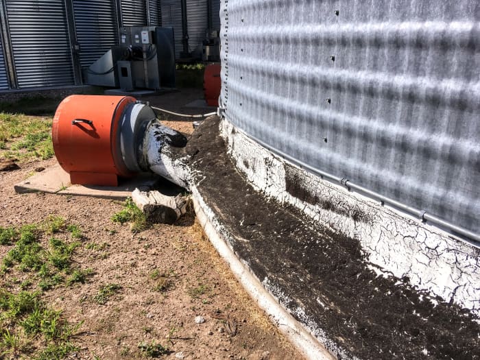 Tar as a sealant between sheets and foundation has kept this bin serviceable for many years, and should continue to do so for many more.