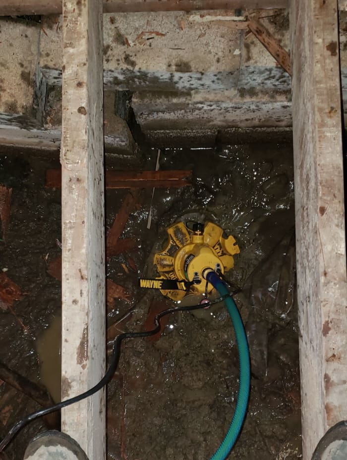 You can see I set the pump in one of the footing holes I started to dig. I pulled all the surface water and brought it down to the level I had dug.