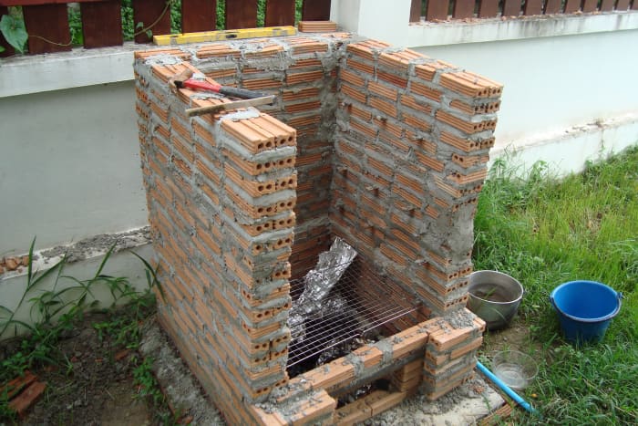 Note the gap I left for the gas burner and the angle iron that bridges the gap (click on the pic to see it larger). You can see I actually only have one course of bricks at the very front - which seems to work OK.
