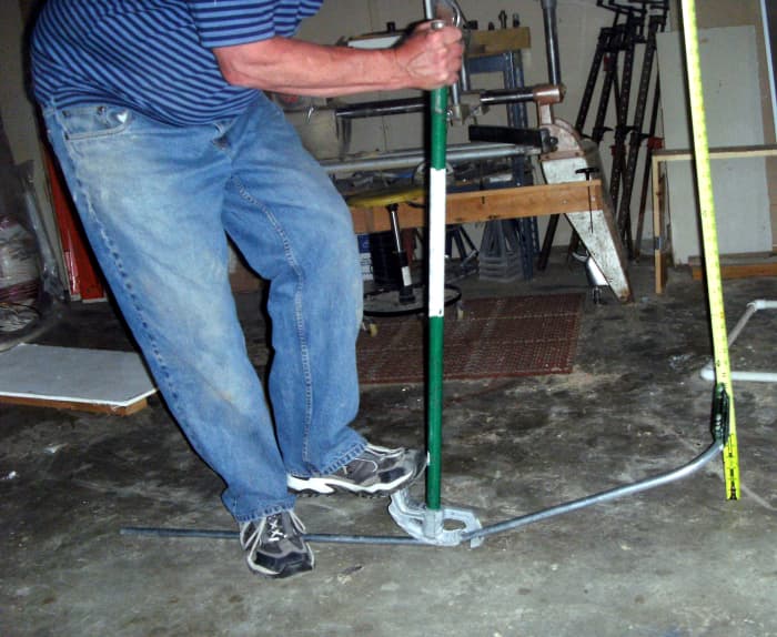 Putting the "kick" into a kick 90. Note the tape measure being used to measure the amount of kick