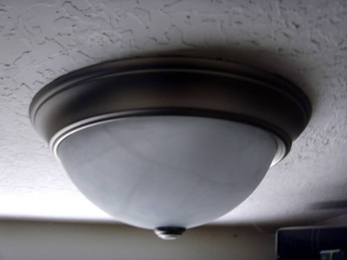The old screws were left in place and reused as the new fixture lined up perfectly. This is common and simplifies the process somewhat.