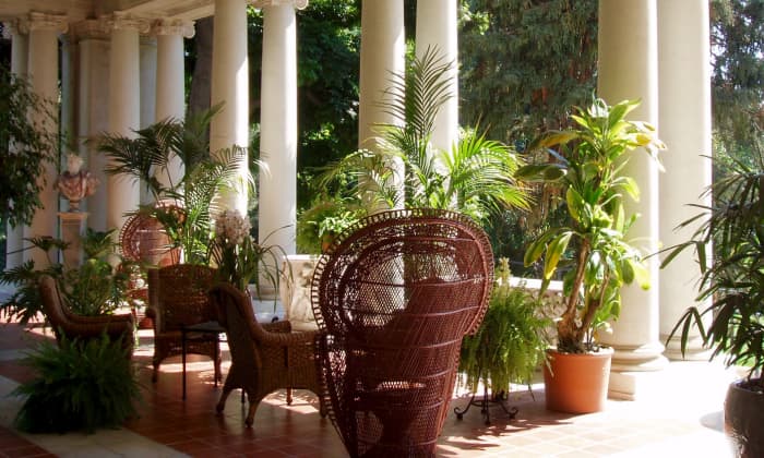 Outdoor patio at the Huntington Gardens in Pasadena, California. Your patio doesn't have to have fancy columns to feel decorative and graceful. The right patio furniture and potted plants will do, supported by a nice tile, stone, or wood floor.