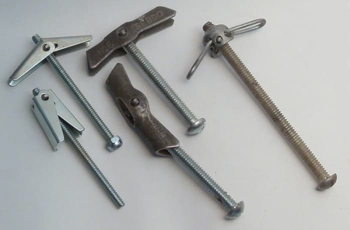 Spring toggle anchors