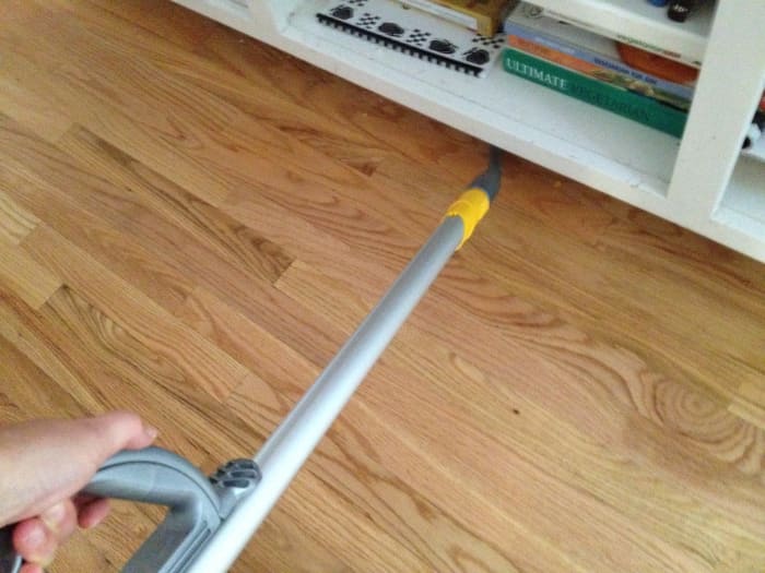 Use a vacuum cleaner attachment to reach under cabinets in the kitchen and other tough spots.