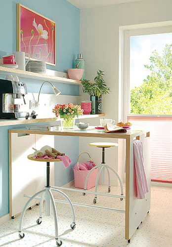 A Nicely Arranged Kitchen with a Wheeled Kitchen Island that can also Serve as a Dining Table