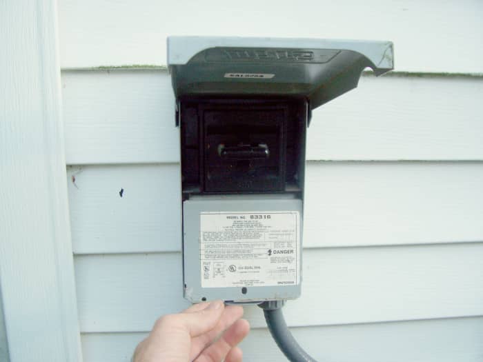 Here, you can see the door of the disconnect is open and the cover is being removed to expose the wires.